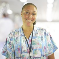 Smiling woman wearing scrubs